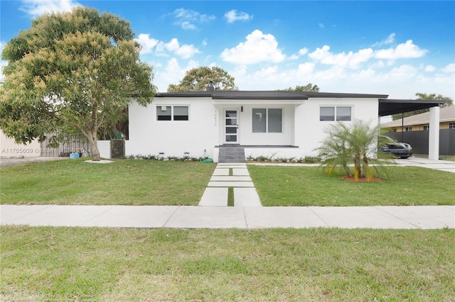 view of front of property with a front yard and a carport