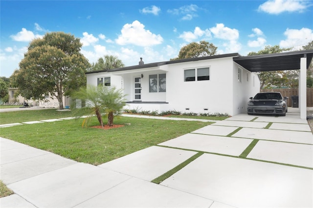 view of front facade with a front yard and a carport