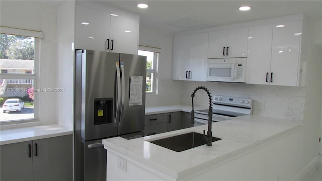 kitchen with white cabinets, plenty of natural light, and stainless steel fridge with ice dispenser