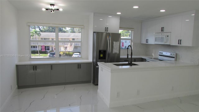 kitchen featuring white cabinetry, plenty of natural light, white appliances, and sink