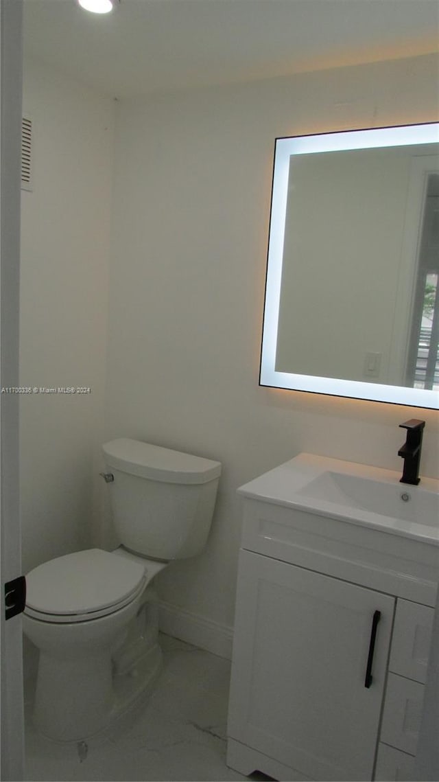 bathroom featuring vanity and toilet