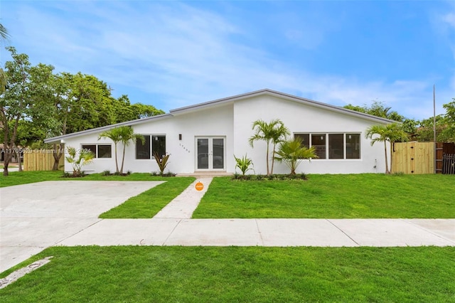 ranch-style house with french doors and a front lawn