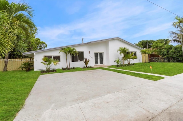 view of front of property with a front yard and french doors