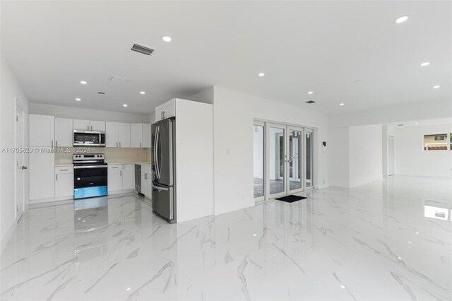 kitchen featuring white cabinetry, stainless steel appliances, and french doors