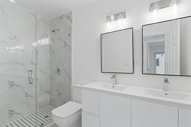 bathroom featuring vanity, toilet, and an enclosed shower