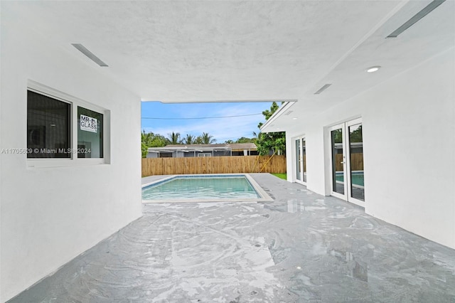 view of swimming pool featuring french doors