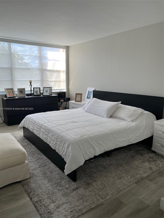 bedroom with hardwood / wood-style flooring