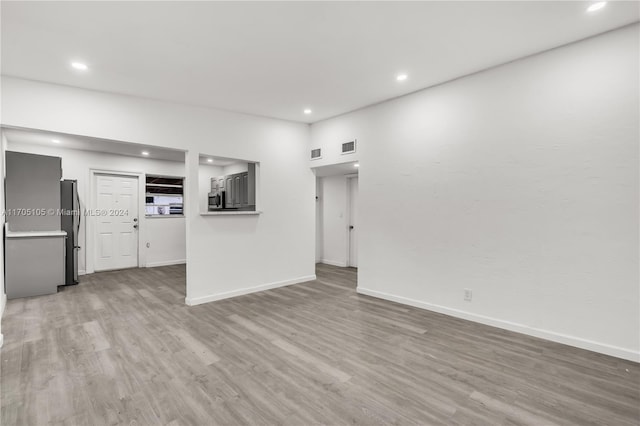 unfurnished living room featuring light hardwood / wood-style flooring