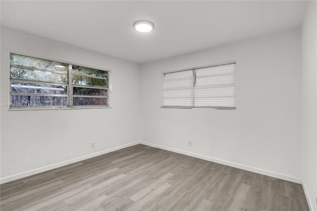 unfurnished room with hardwood / wood-style floors