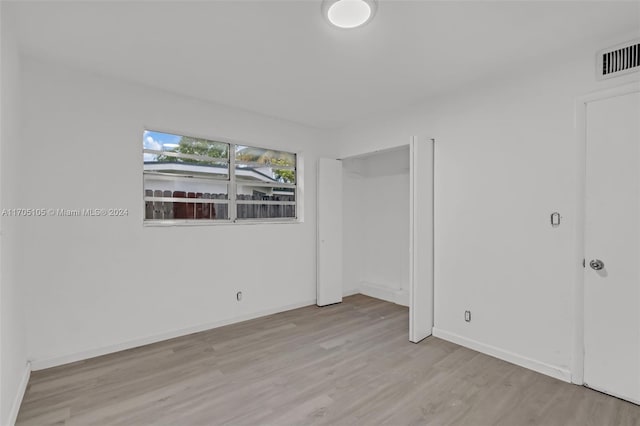 spare room featuring light wood-type flooring