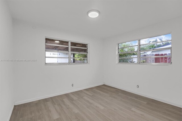 unfurnished room with plenty of natural light and light hardwood / wood-style floors