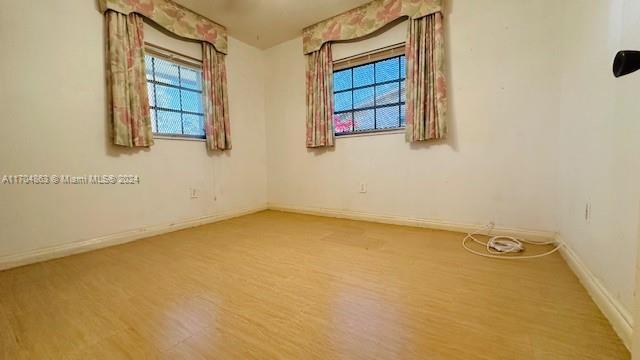 spare room featuring hardwood / wood-style floors