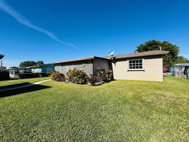 view of property exterior featuring a yard