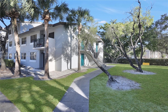 view of side of home with a yard