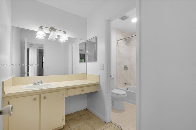 full bathroom featuring tile patterned flooring, vanity, tiled shower / bath combo, and toilet