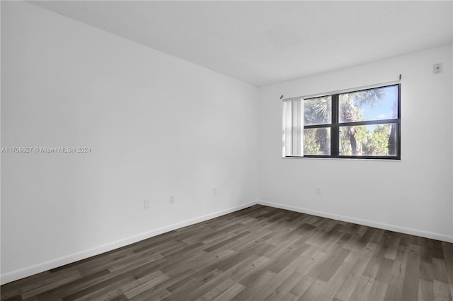 unfurnished room featuring dark hardwood / wood-style floors