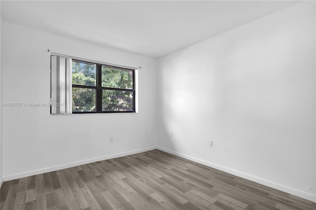 spare room with wood-type flooring