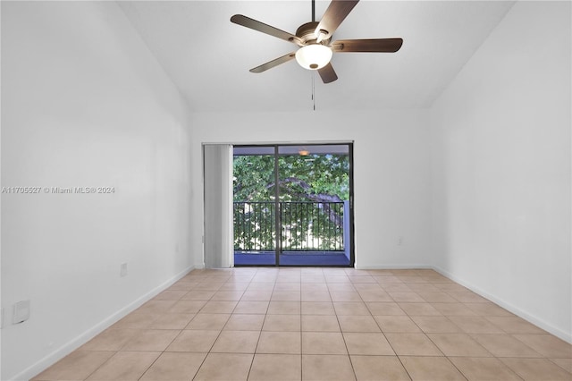 tiled spare room with vaulted ceiling and ceiling fan