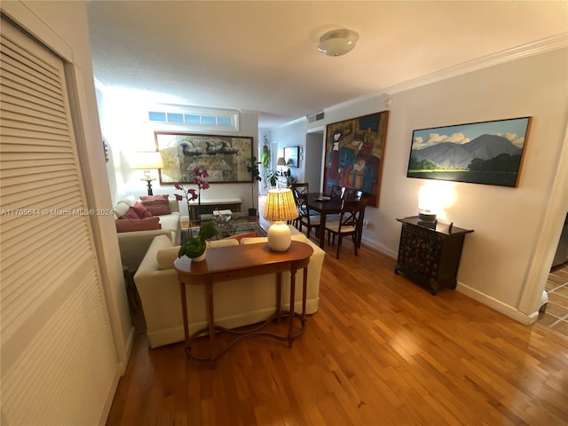 living room with hardwood / wood-style floors and ornamental molding