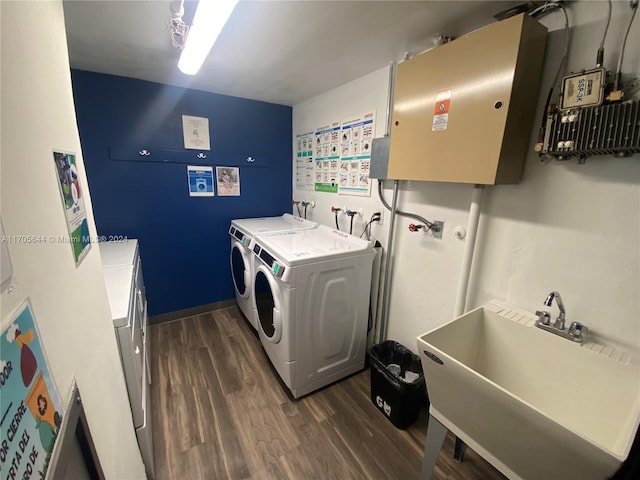 laundry area with sink, dark hardwood / wood-style floors, and washing machine and clothes dryer