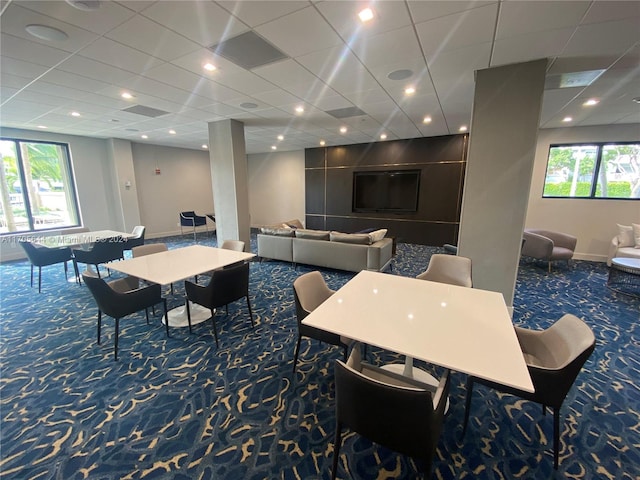 dining space featuring dark carpet and a healthy amount of sunlight