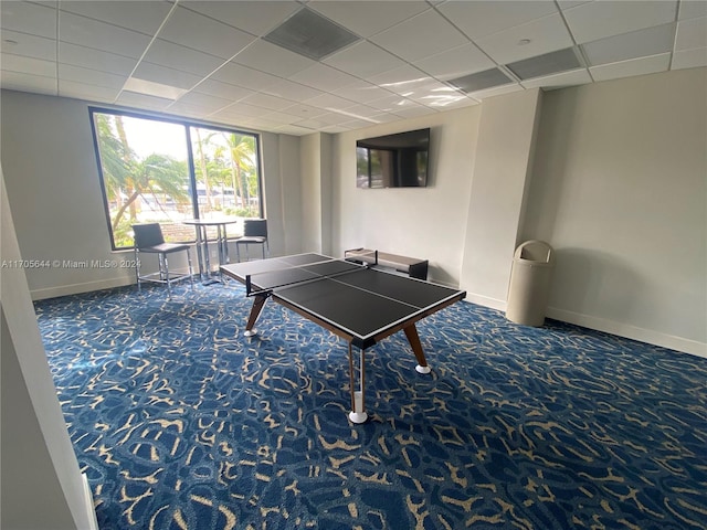 playroom with carpet and a paneled ceiling