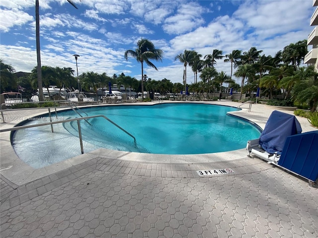 view of swimming pool featuring a patio area