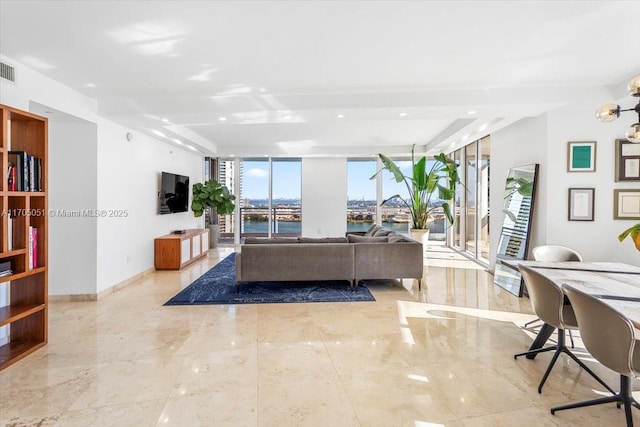 living room with expansive windows and baseboards