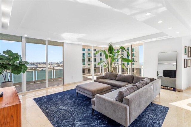 living room featuring a notable chandelier and a water view