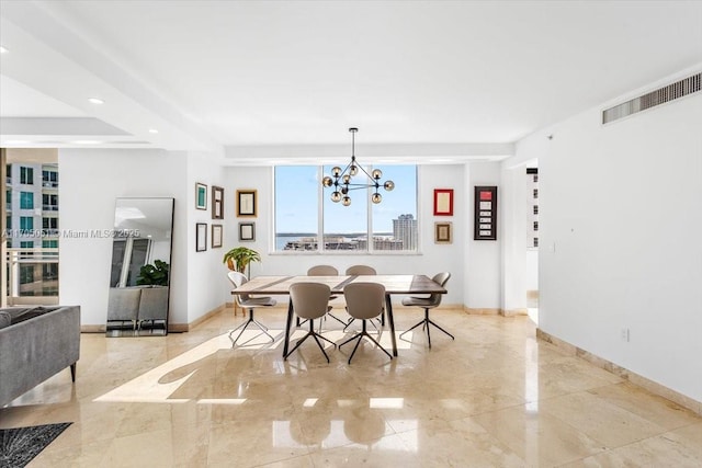 dining space with a chandelier, marble finish floor, visible vents, and baseboards