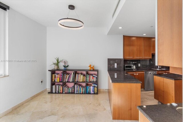 kitchen with decorative backsplash, dark stone counters, dishwasher, a center island, and hanging light fixtures