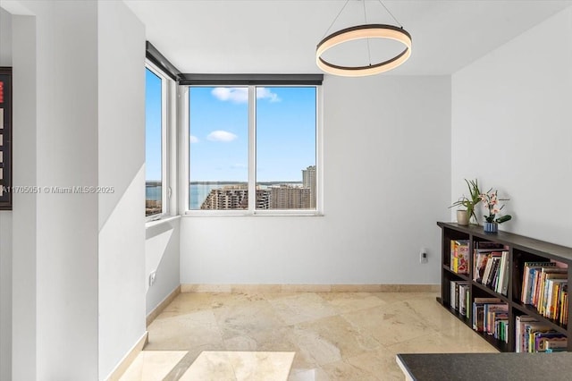 interior space featuring a city view and baseboards