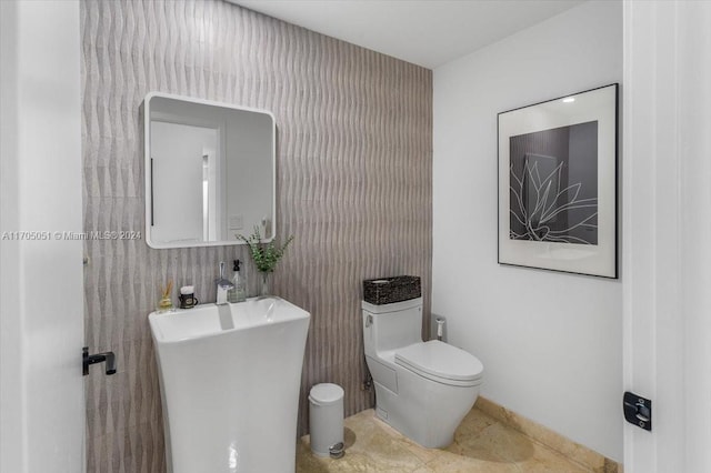 bathroom featuring tile patterned floors, sink, and toilet