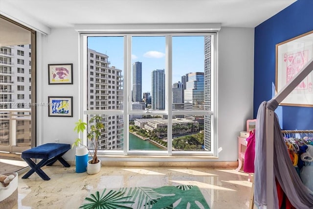 entryway with marble finish floor, a view of city, and a wealth of natural light