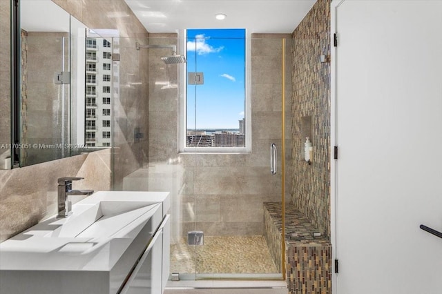 bathroom featuring vanity and an enclosed shower