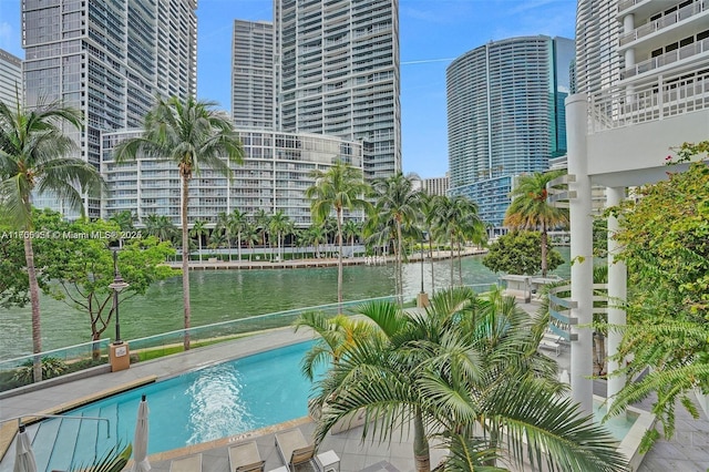 community pool featuring a water view and a city view