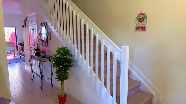 stairs with tile patterned floors