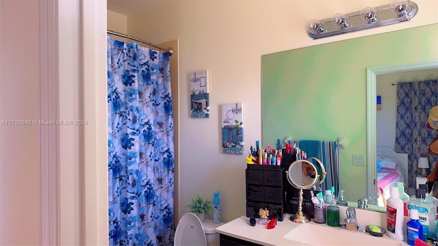 bathroom featuring vanity, toilet, and walk in shower