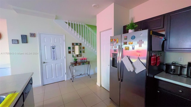 kitchen featuring dark brown cabinets, stainless steel fridge with ice dispenser, and light tile patterned floors