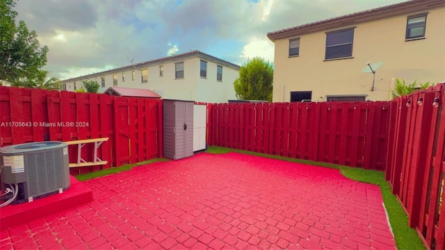 view of patio featuring a storage unit and cooling unit