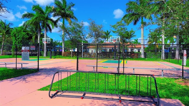 view of sport court featuring a yard