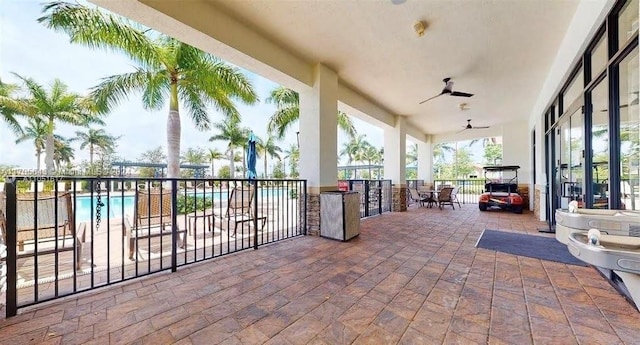 view of patio with a fenced in pool and ceiling fan