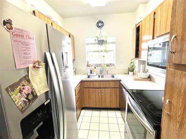 4747 Collins Ave Unit 503, Miami Beach, FL 33140 - kitchen with appliances with stainless steel finishes, a sink, light tile patterned floors, light countertops, and brown cabinetry