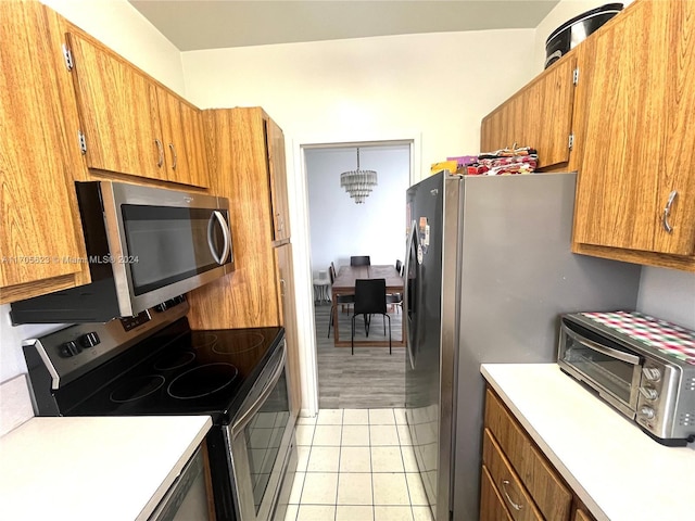 kitchen with a chandelier, light hardwood / wood-style flooring, and stainless steel appliances