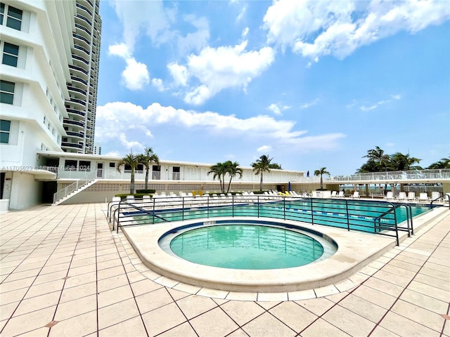 view of pool with a community hot tub