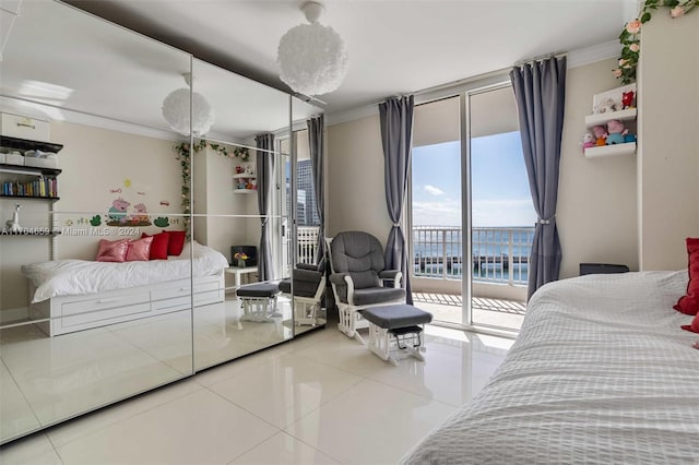 bedroom featuring tile patterned floors, ornamental molding, access to outside, and multiple windows