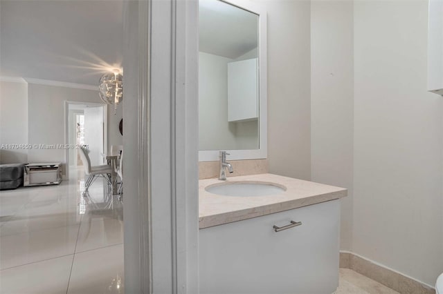 bathroom featuring crown molding, tile patterned flooring, and vanity