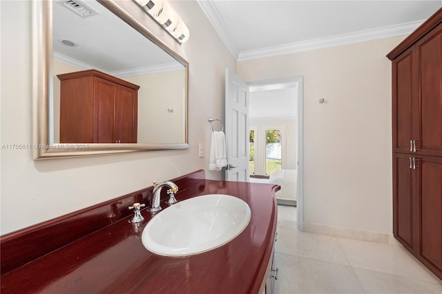 bathroom with tile patterned flooring, vanity, and crown molding