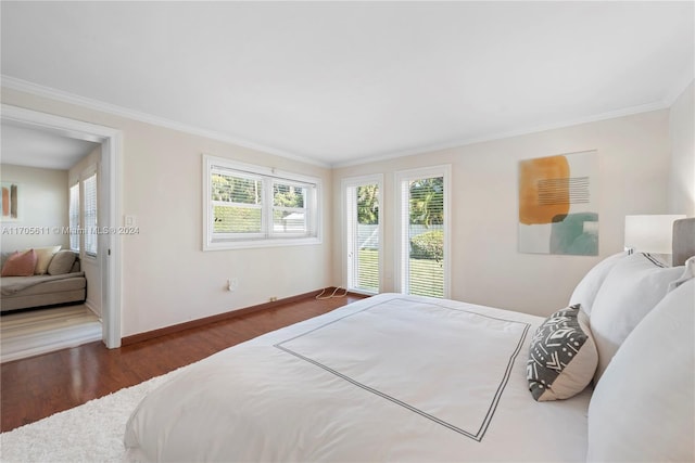 bedroom with dark hardwood / wood-style floors and crown molding