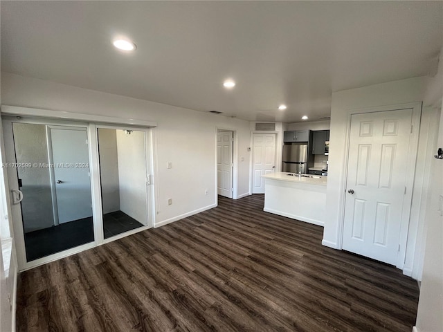 unfurnished living room featuring dark hardwood / wood-style floors